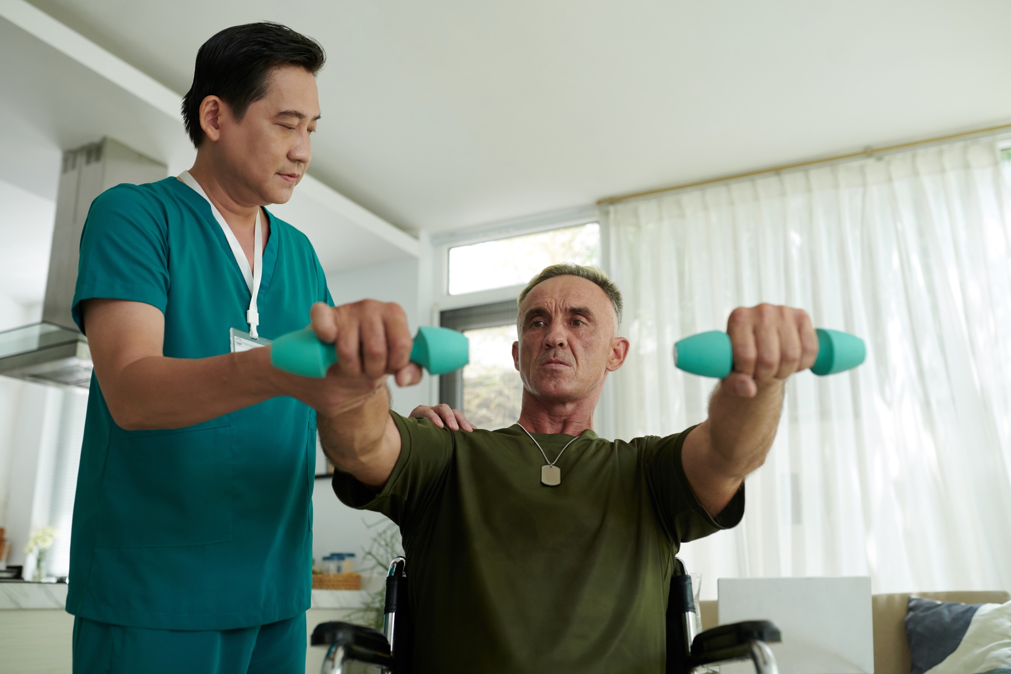 Asian Doctor Helping Soldier During Rehab